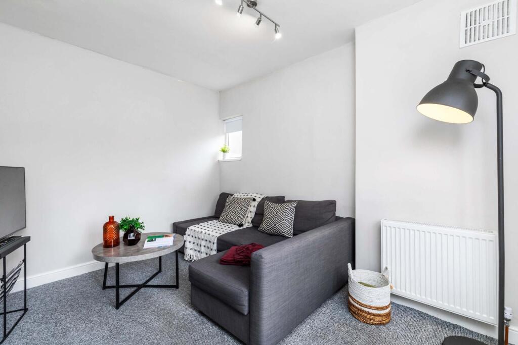 A bright and modern living room featuring a com...