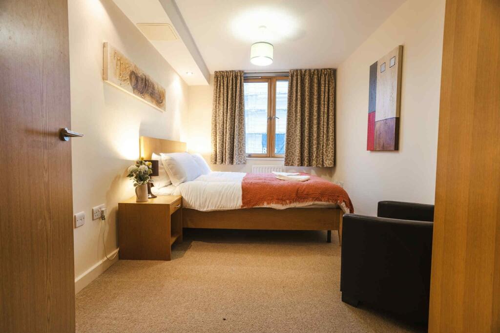 A cozy and well-maintained double bedroom featu...