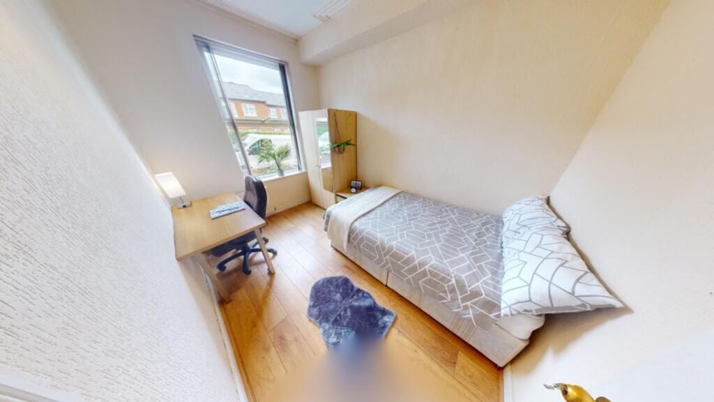 A bright and tidy double bedroom featuring a co...