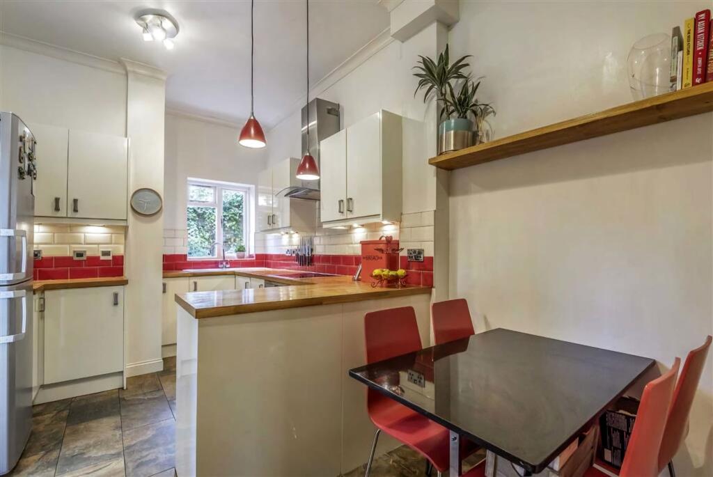 A bright and inviting kitchen featuring white c...