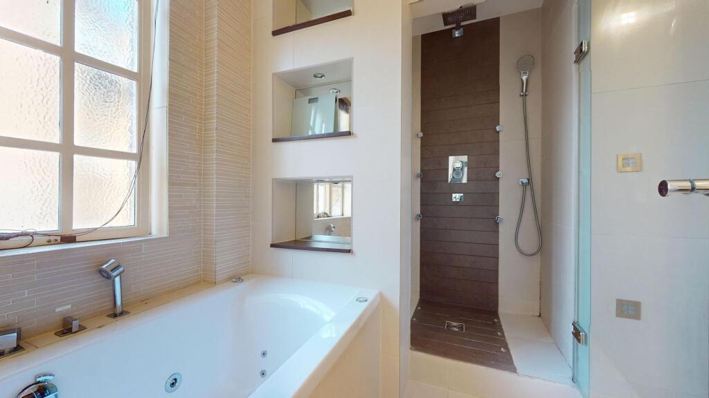 A bright and modern bathroom suite featuring a ...