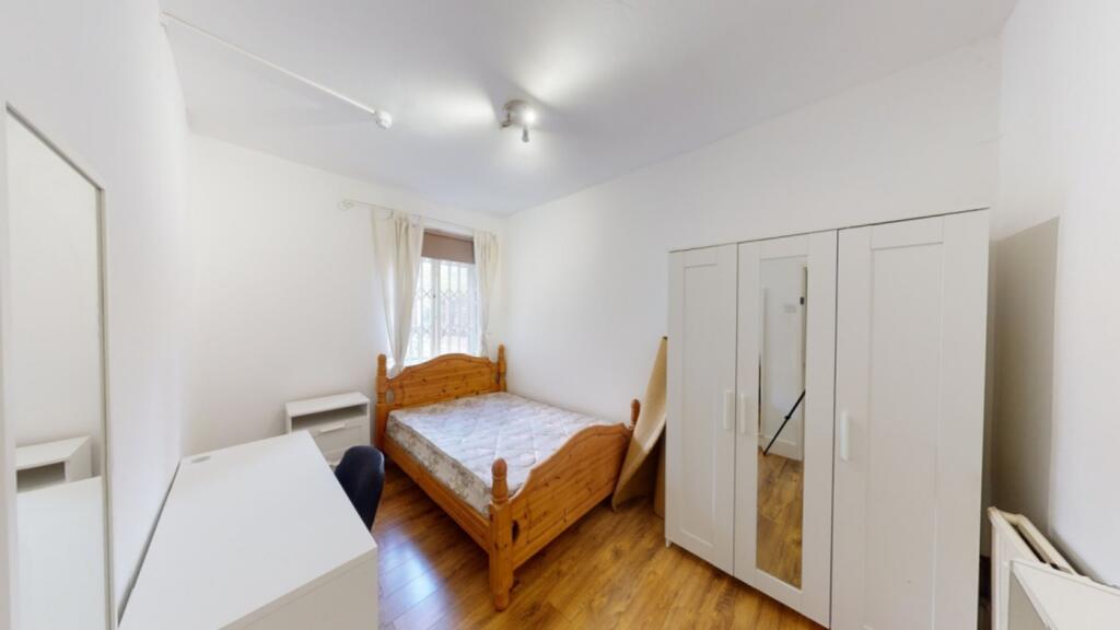 A bright and welcoming double bedroom featuring...