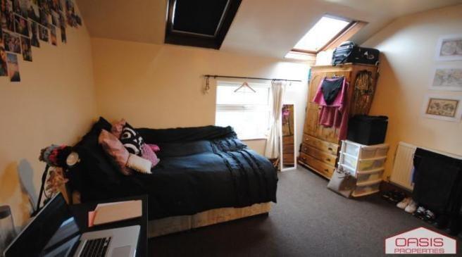 A cozy bedroom featuring a double bed, a window...