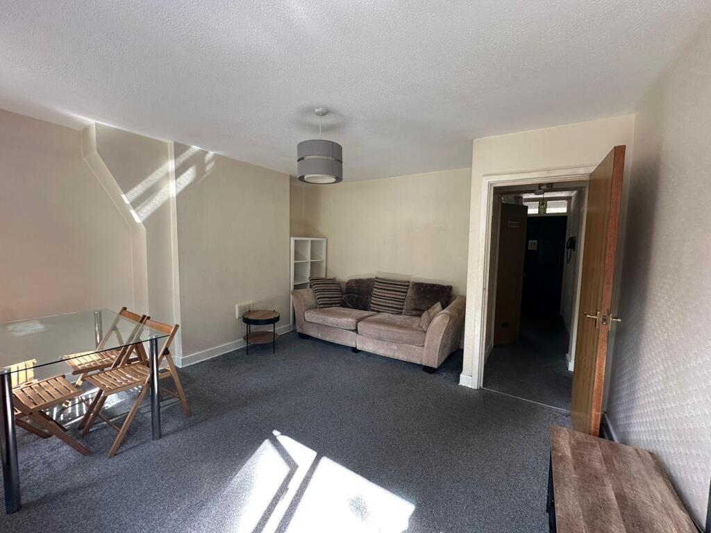 A bright living room featuring a comfortable so...