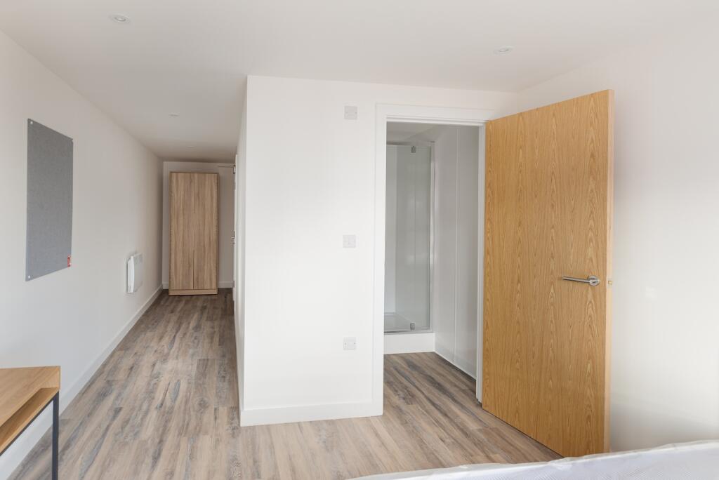 A spacious and modern double bedroom, featuring...
