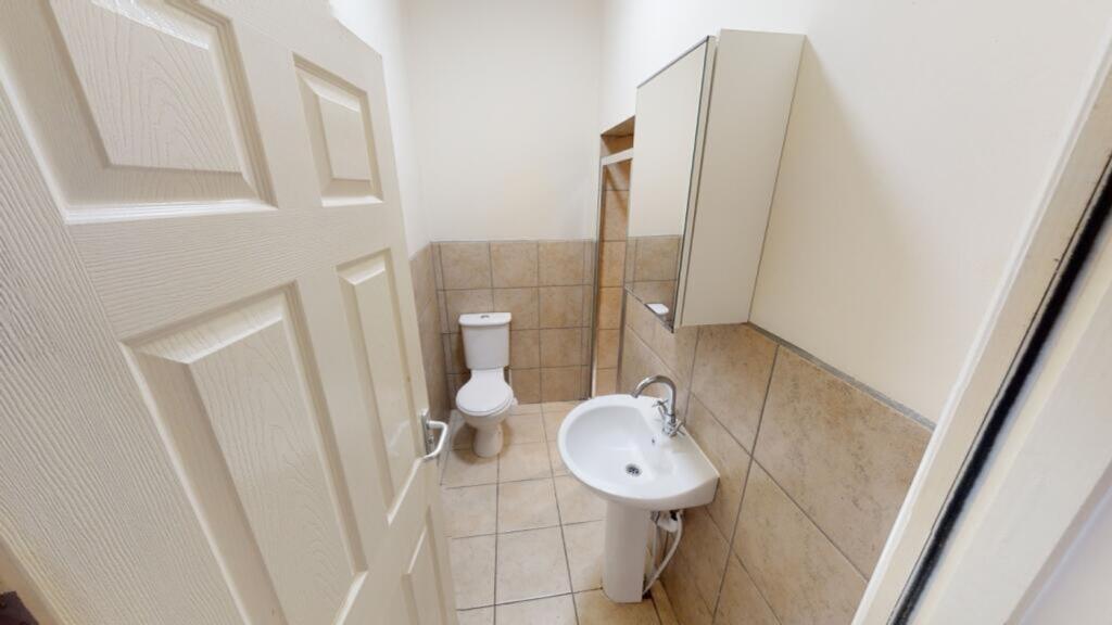 A tidy and functional bathroom featuring modern...