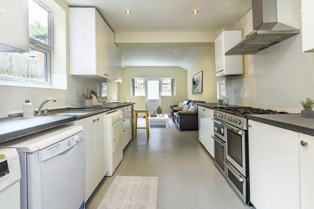 Bright and modern kitchen featuring sleek white...