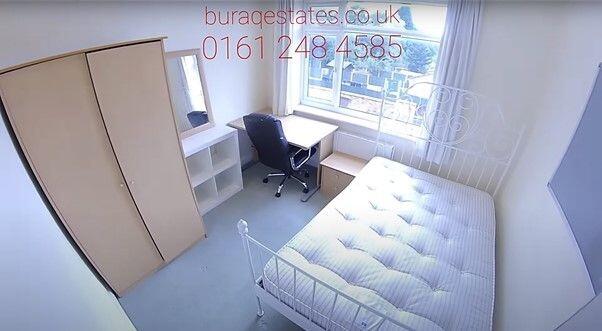 Bright, simply furnished bedroom with a comfort...