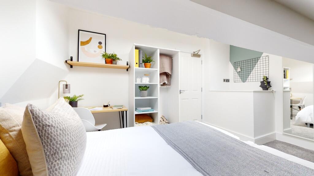 A bright and inviting double bedroom with moder...