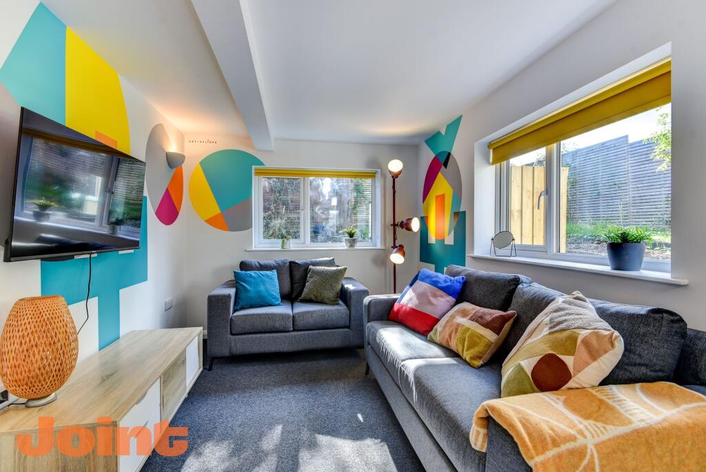 Bright and contemporary living room featuring s...