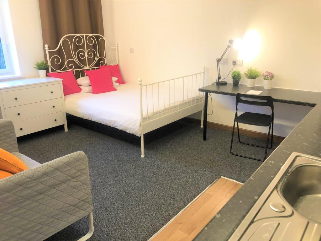 Bright and welcoming double bedroom featuring a...