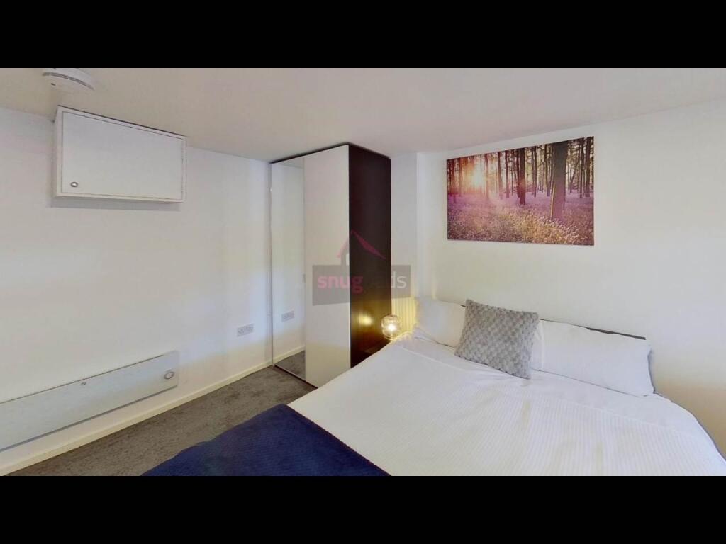 A spacious and comfortably decorated master bed...
