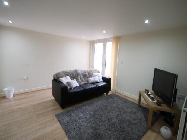 A bright and tidy living room with a comfortabl...