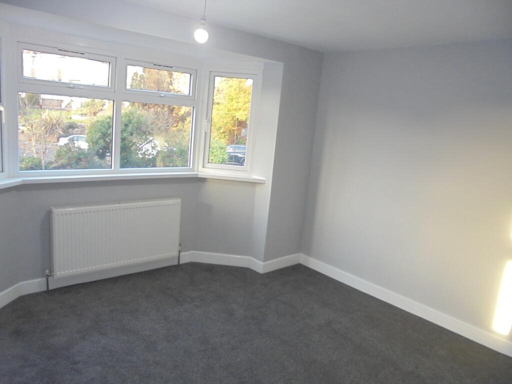 A spacious and bright double bedroom featuring ...