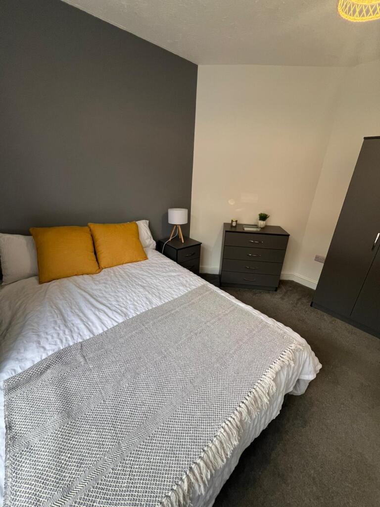A stylish double bedroom featuring a comfortabl...