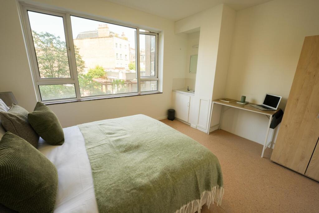 Bright and tidy double bedroom featuring a larg...