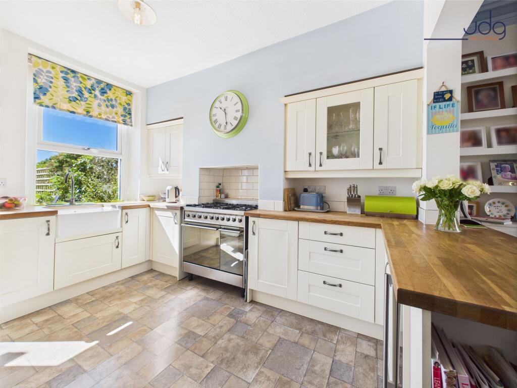Shaker style kitchen with solid wooden worksurfaces and belfast sink