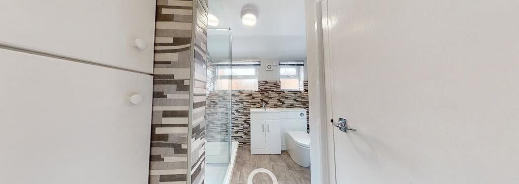 Modern bathroom featuring a large shower, a sle...