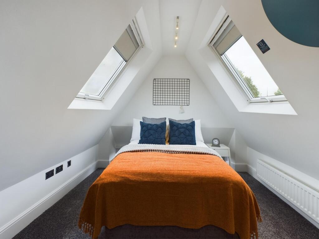 A bright and stylish double bedroom featuring l...