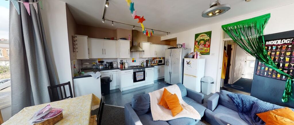 A spacious and bright kitchen with modern appli...