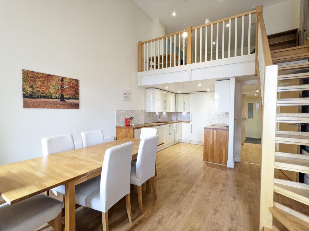 Bright open-plan living and dining area with hi...