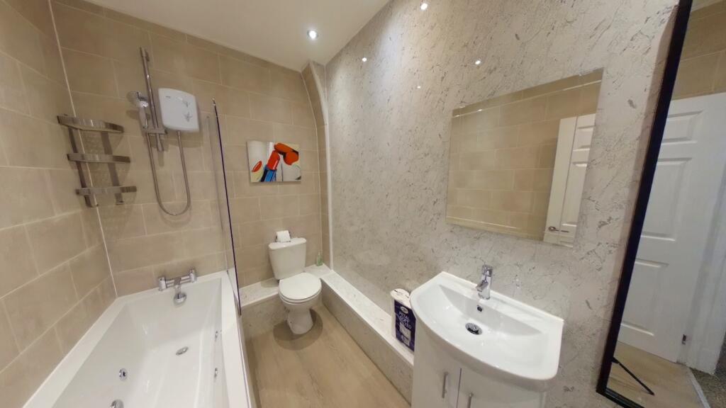 A spacious and immaculate bathroom featuring a ...