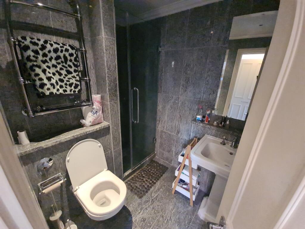 A clean and modern bathroom featuring a toilet,...