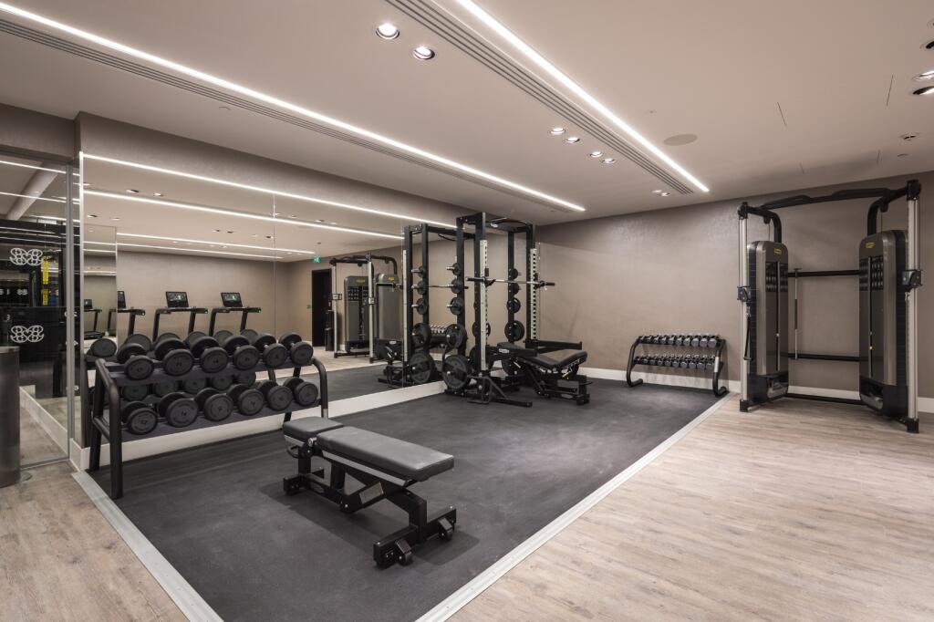 A modern, well-equipped gym featuring a variety...