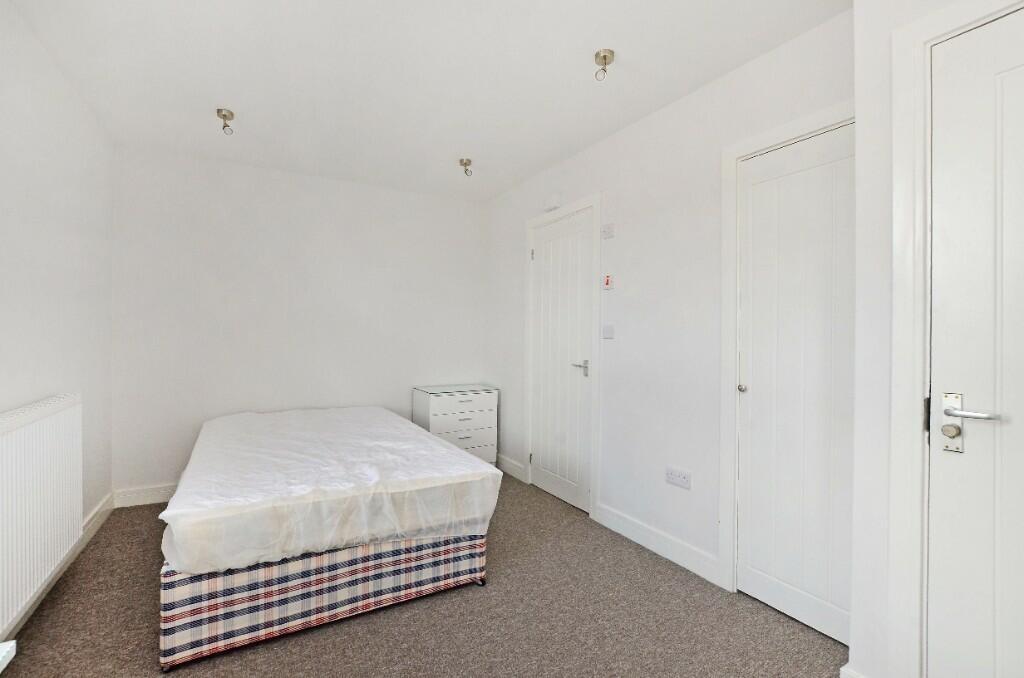 Bright and tidy double bedroom featuring a comf...