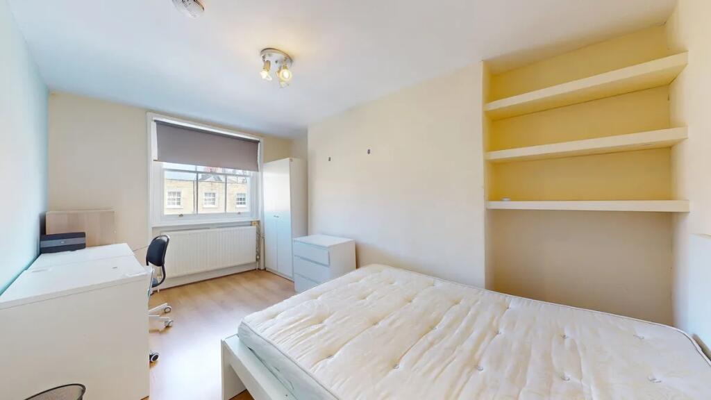 Bright and tidy double bedroom featuring a comf...