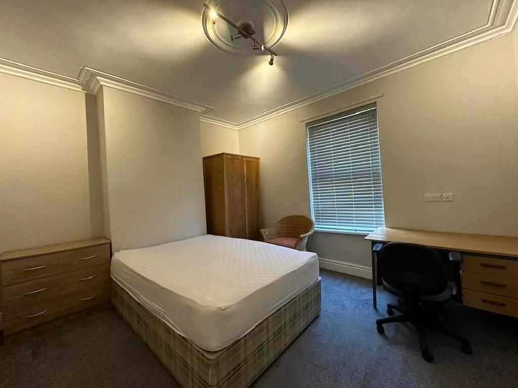 A cozy double bedroom featuring a comfortable m...