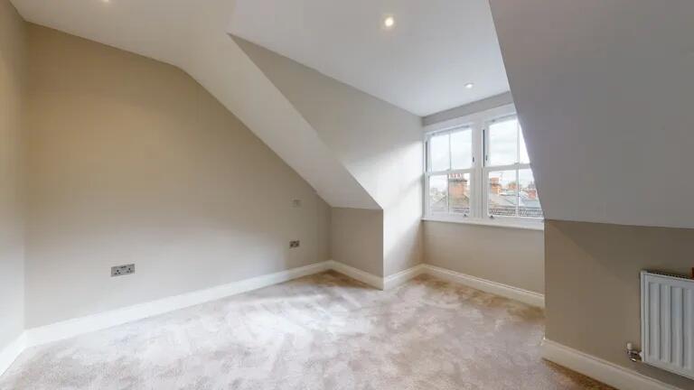 Bright and airy bedroom featuring a large windo...