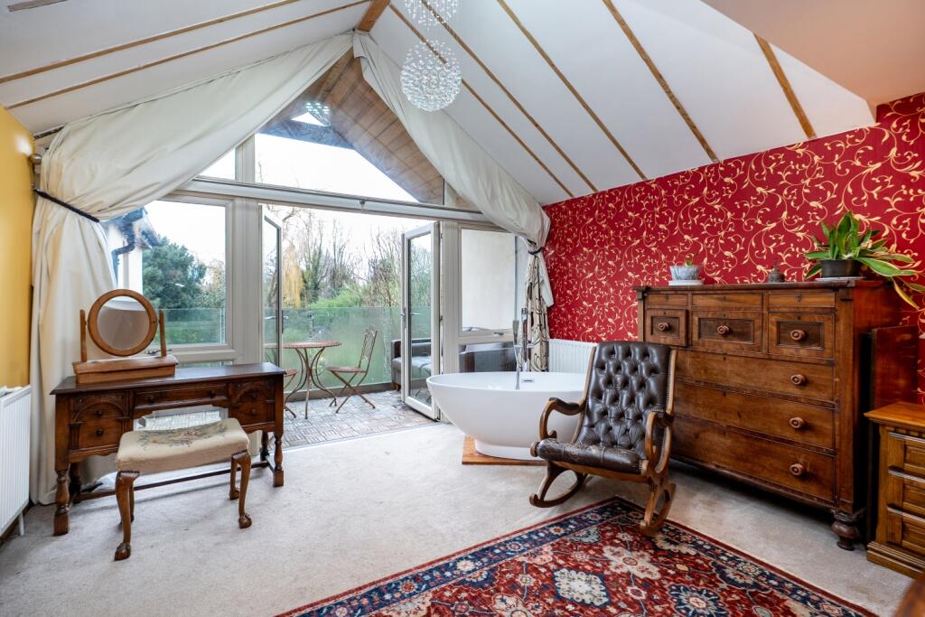 A luxurious main bedroom with private balcony walk