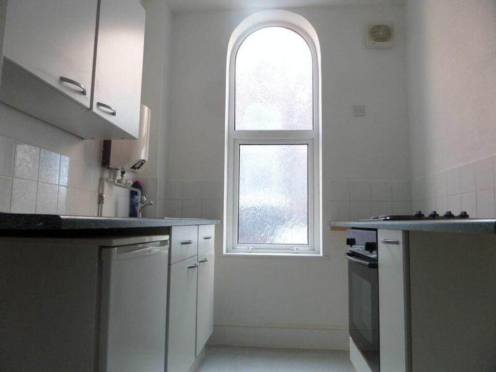 A tidy and bright kitchenette with modern appli...