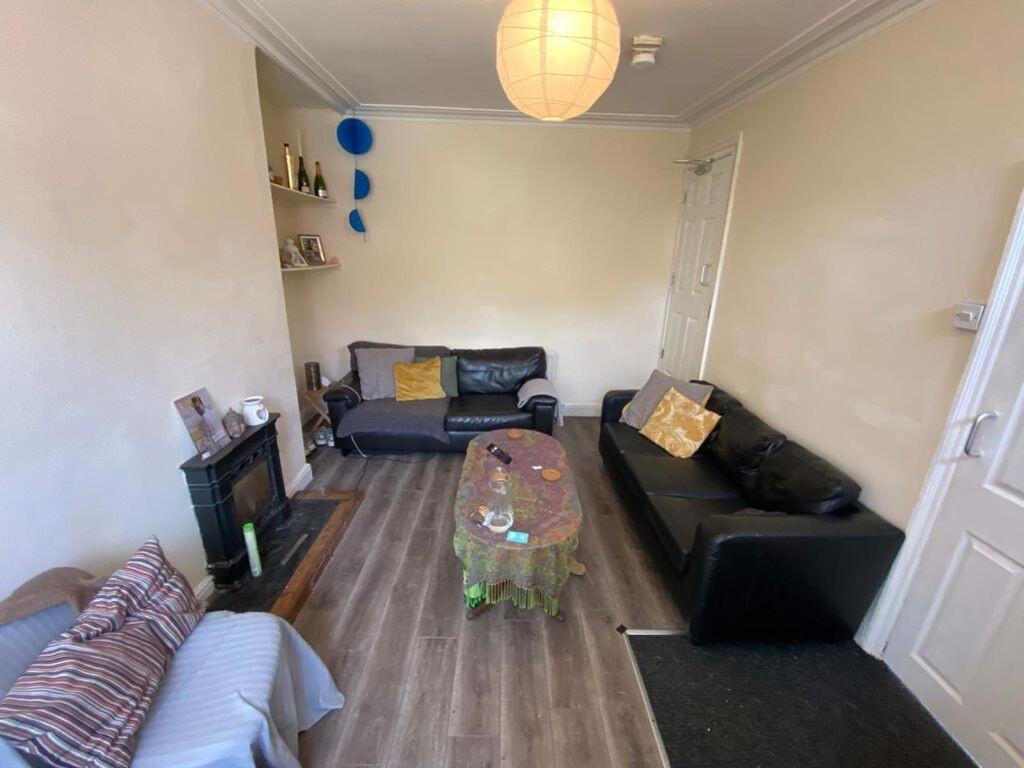 A spacious, well-lit living room featuring mode...