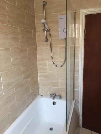 A clean, modern bathroom suite featuring a spac...