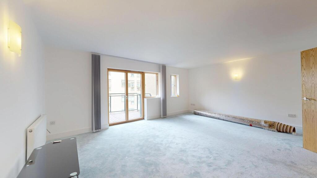 Bright and spacious living room with large wind...