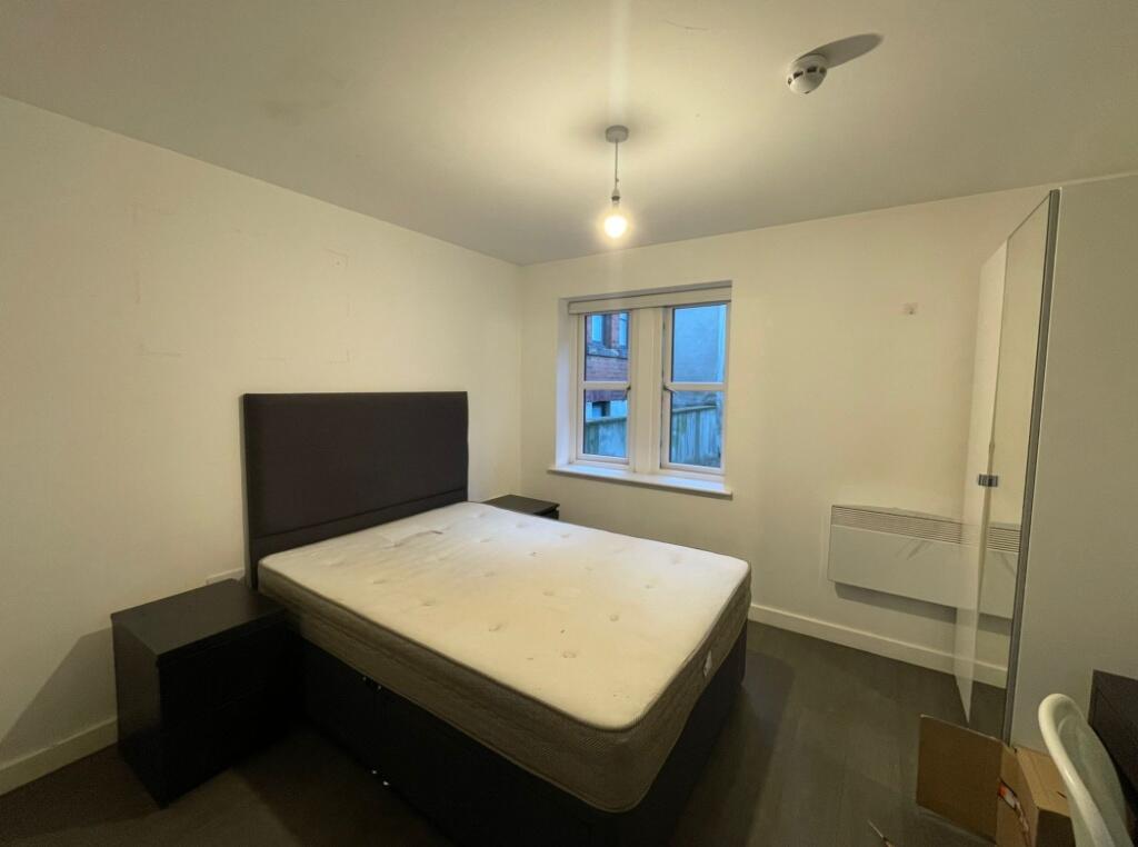 A tidy double bedroom featuring a comfortable d...
