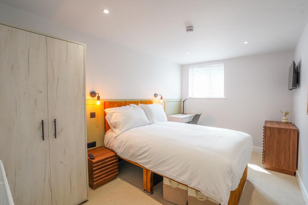Bright and welcoming bedroom featuring a comfor...