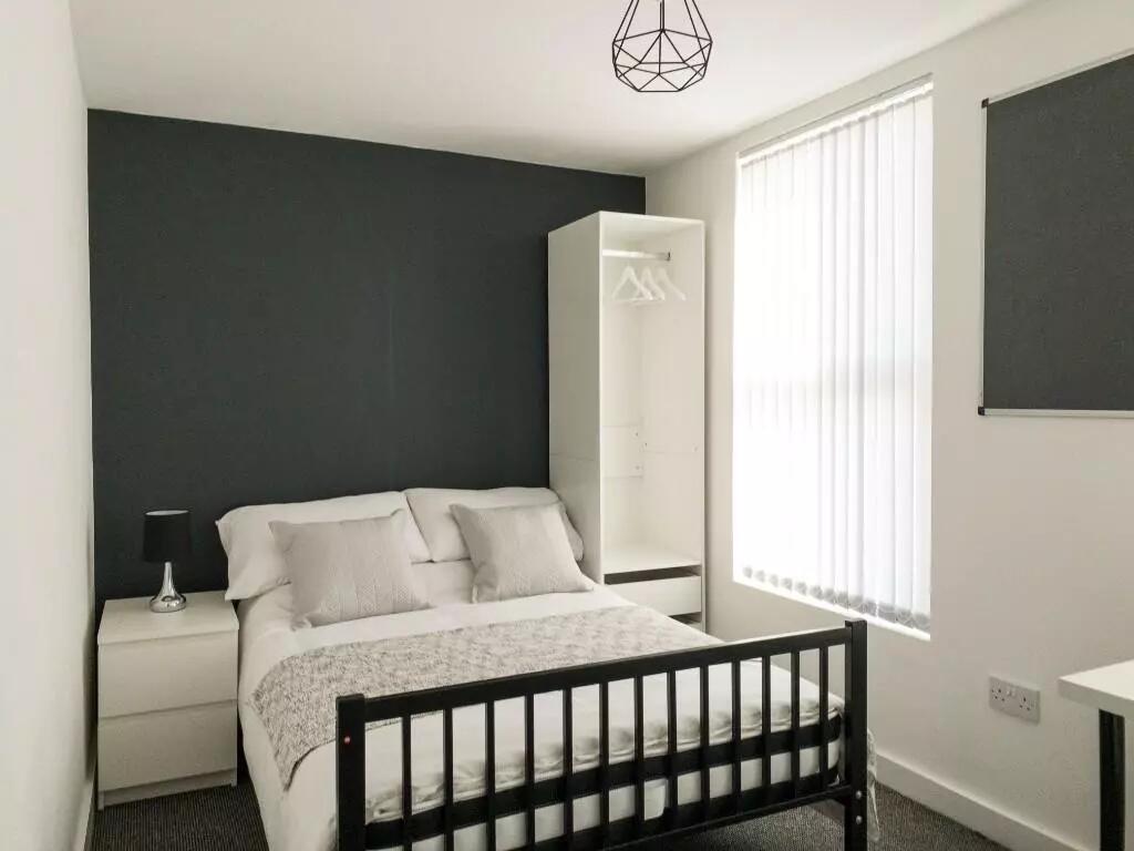 A cozy double bedroom featuring a comfortable d...