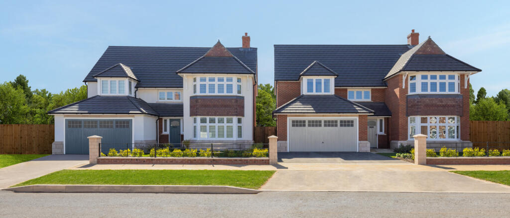 Two modern detached houses with brick and white facades, large bay windows, and well-maintained fron