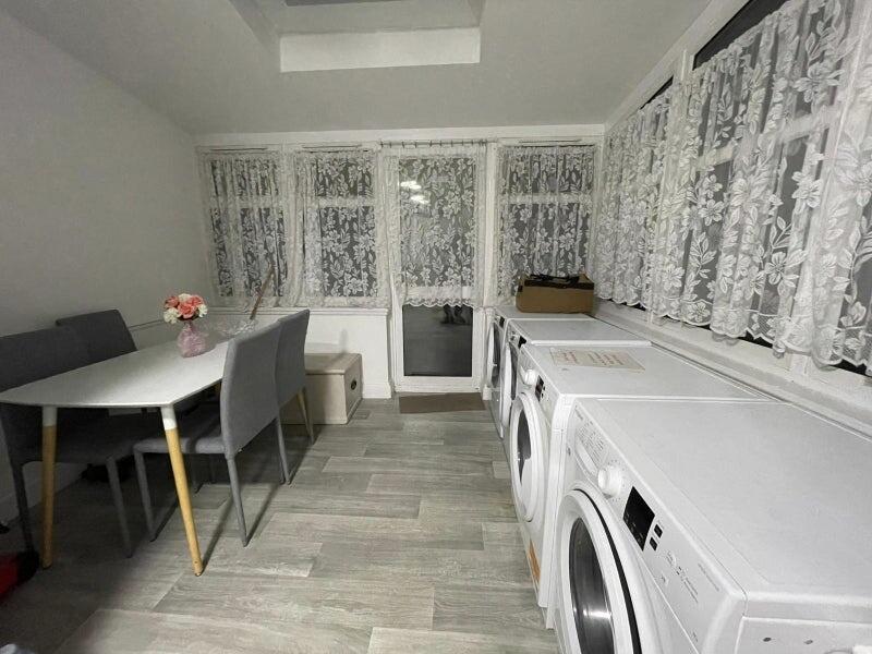 Bright, tidy communal room with large windows, ...