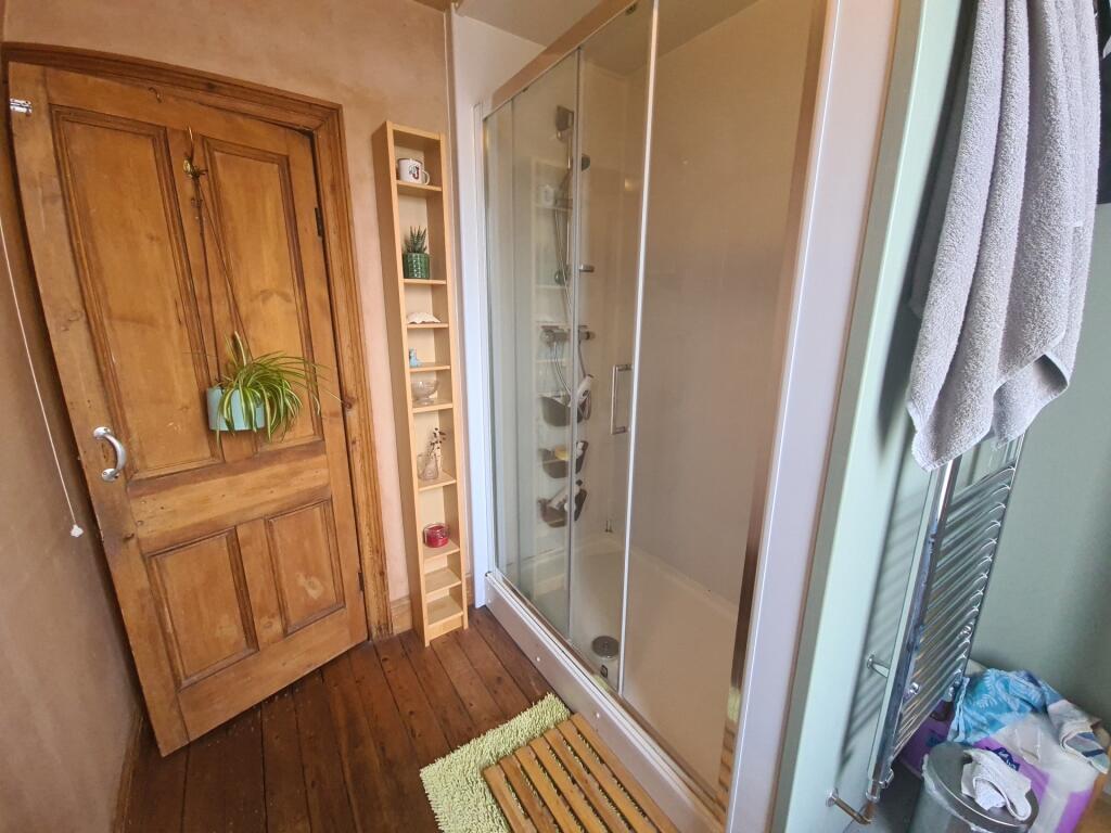 A bright and well-maintained bathroom suite fea...