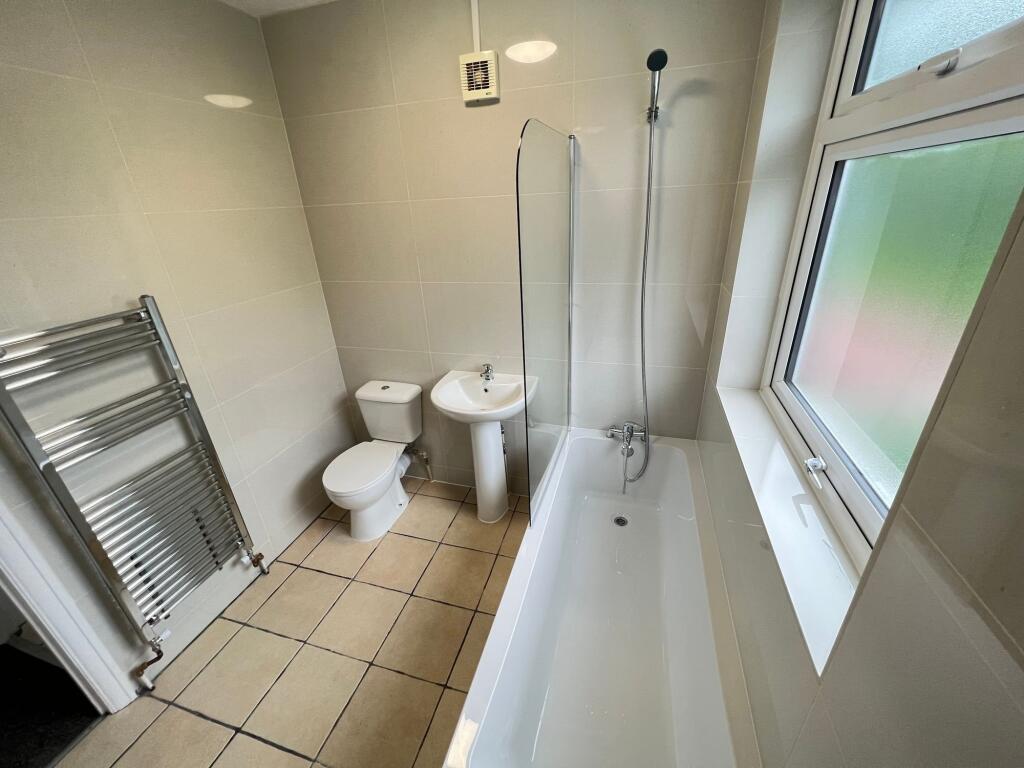 Bright and modern bathroom featuring a clean wh...