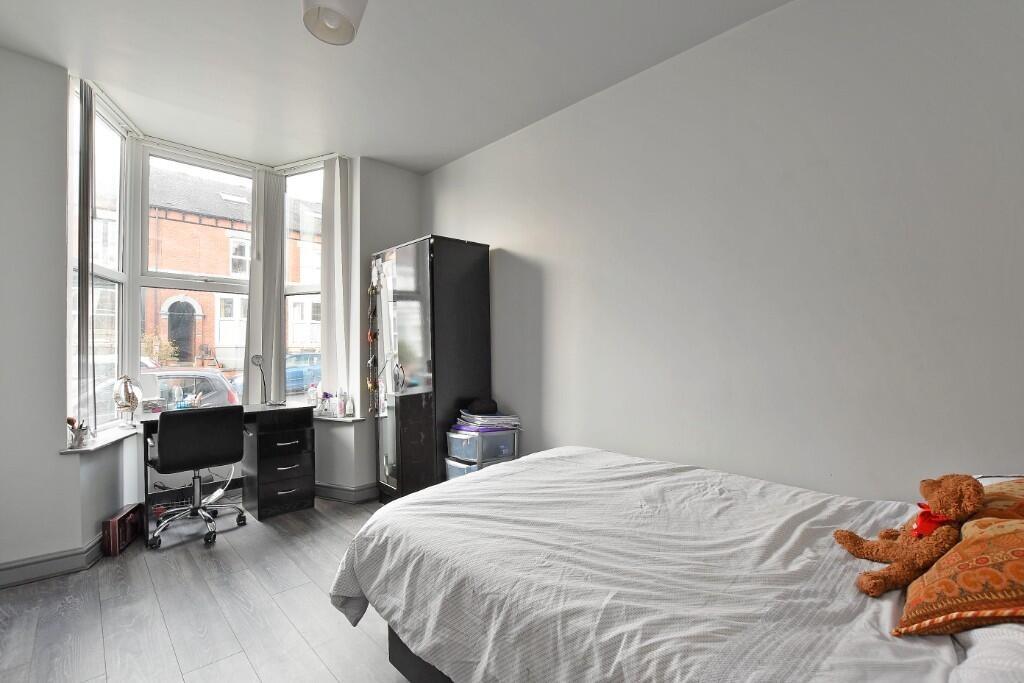 Bright and tidy double bedroom featuring a larg...