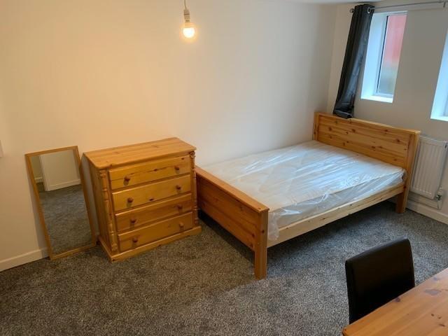 A neat and well-maintained bedroom featuring a ...