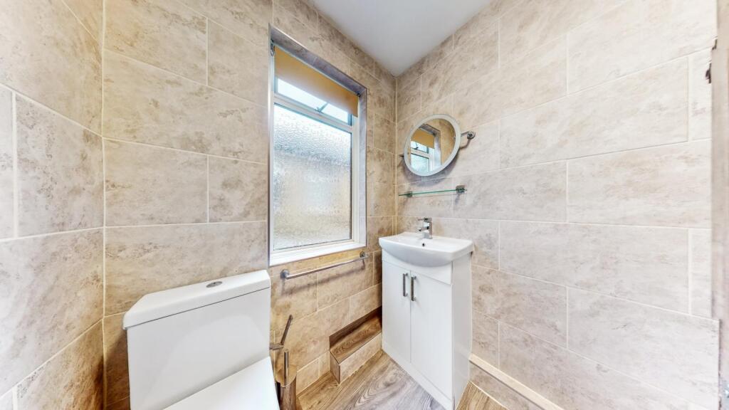 Fully tiled bathroom combined W.C