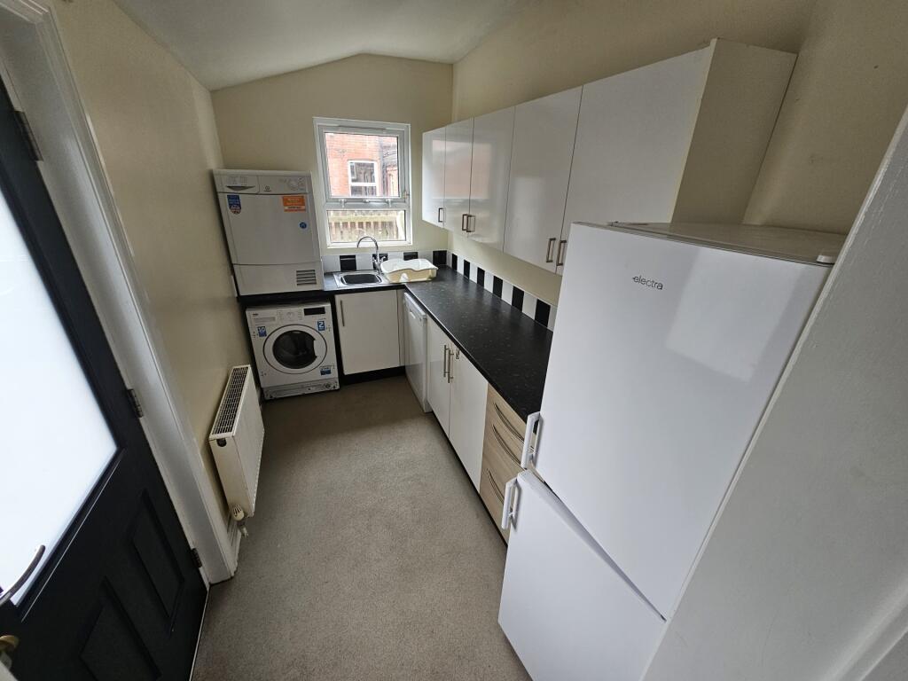 Bright and tidy kitchen featuring modern white ...