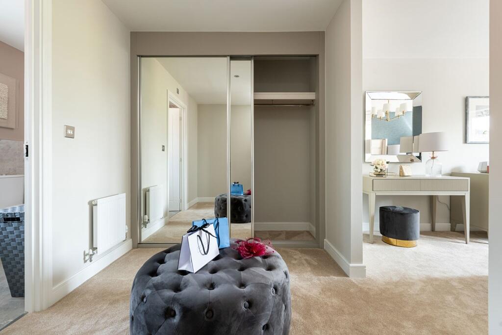 A dedicated dressing area in bedroom 1 boasts space for storage