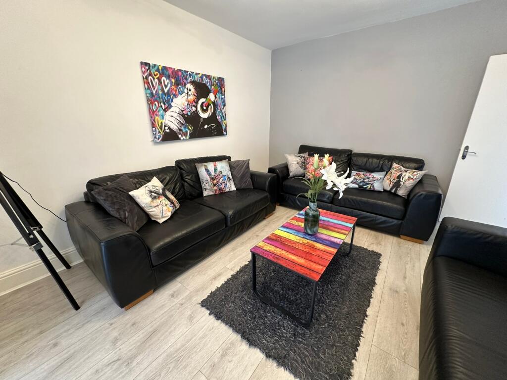 A stylish living room featuring comfortable bla...